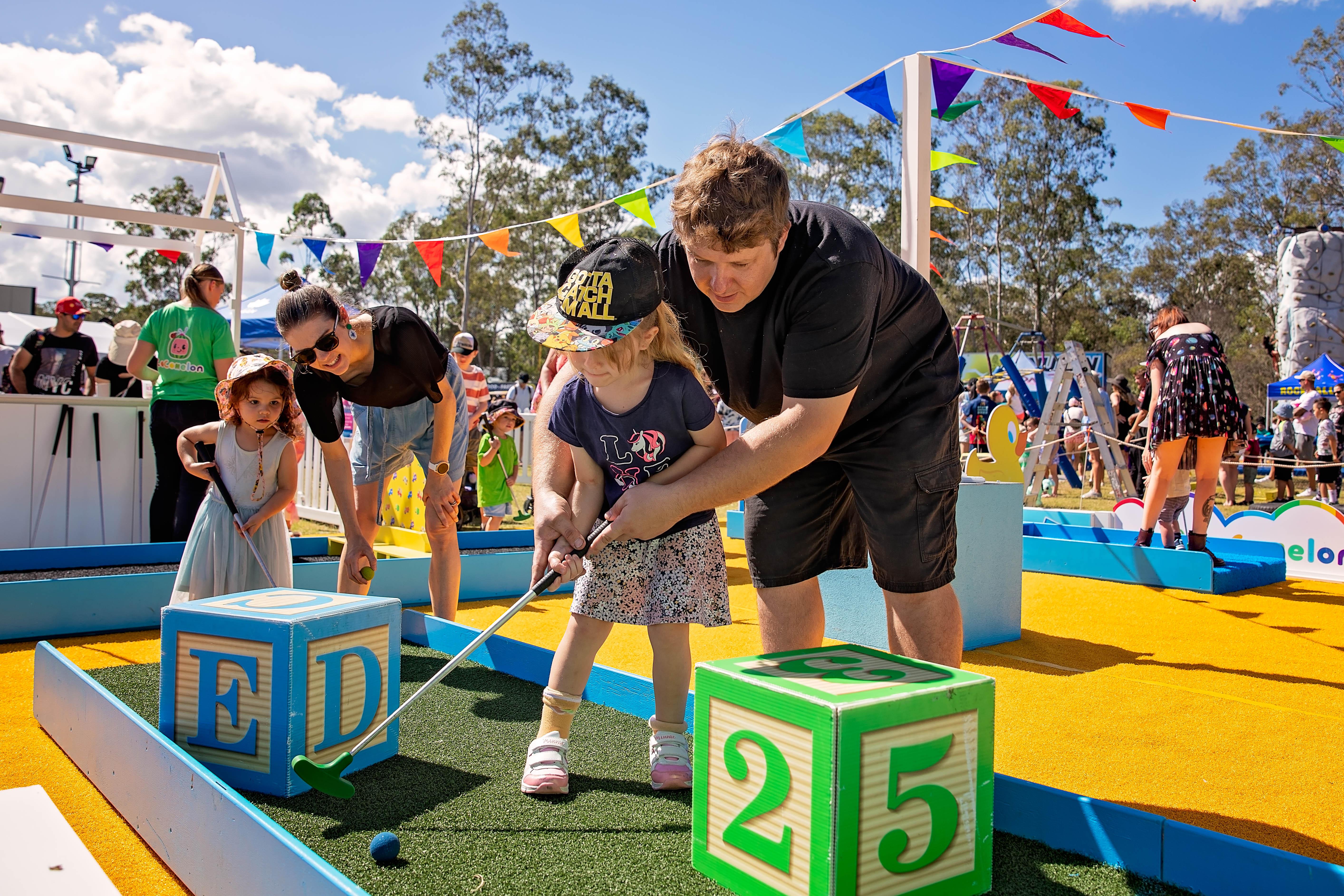 A family playing mini golf