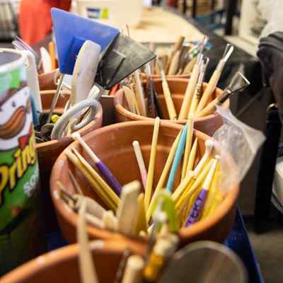 Paint brushes in a clay pot