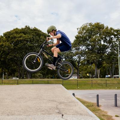 A boy making a jump on his bmx bike