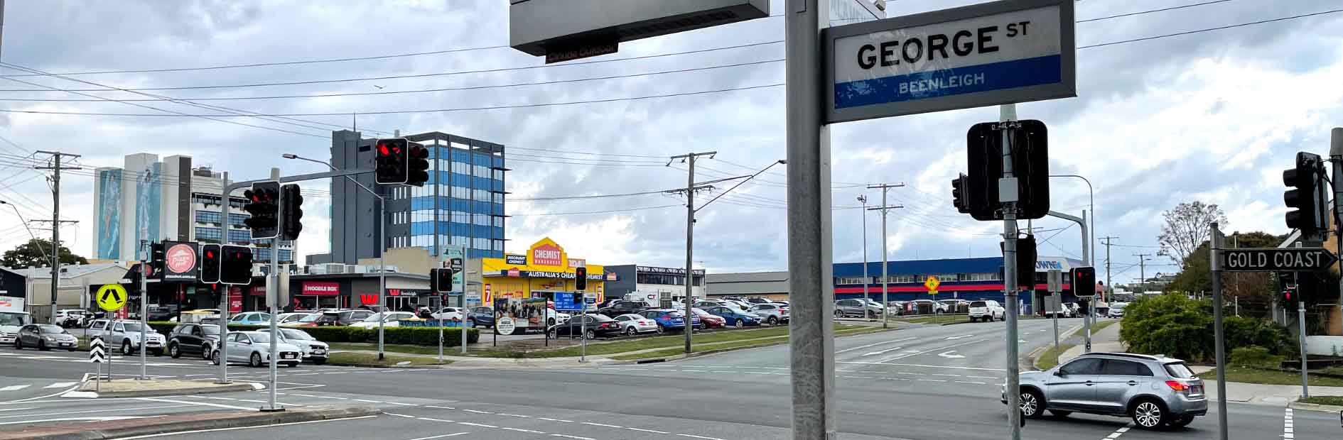 Alamein street intersection Beenleigh showing a sign and cars passing through the intersection