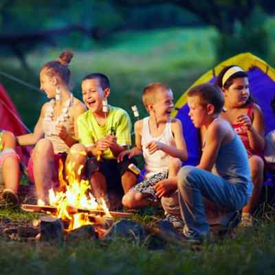 A group of children by a campfire