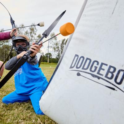 A boy with a dodgebow ready to shoot it