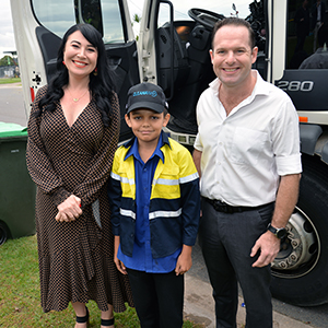 An image of City of Logan Mayor Jon Raven and Division 3 Councillor Mindy Russell helping to deliver a school run surprise for garbage truck fanatic Ethan Nilsen, 11, of Daisy Hill.