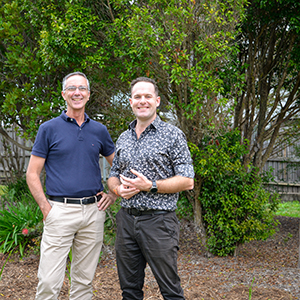 Mayor Jon Raven (right) and Division 5 Councillor Paul Jackson in front of a new buffer garden planted to protect one of the area’s endangered Gossia gonoclada trees.