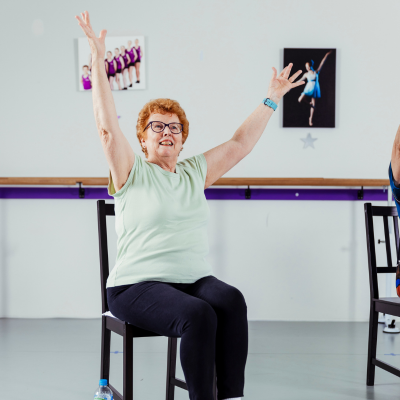 Elderly woman doing seated balllet