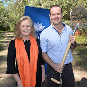 An image of Logan City Council Deputy Mayor Jon Raven with a shovel and City Lifestyle Chair
Laurie Koranski at the sod turning today for the Logan Village to Yarrabilba
Rail Trail. The bush track to be upgraded is in the background.