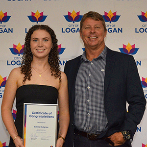 Woman holds certificate and stands next to man