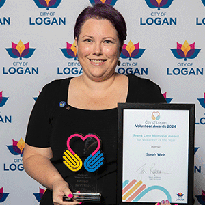 Woman holds trophy and certificate after winning award