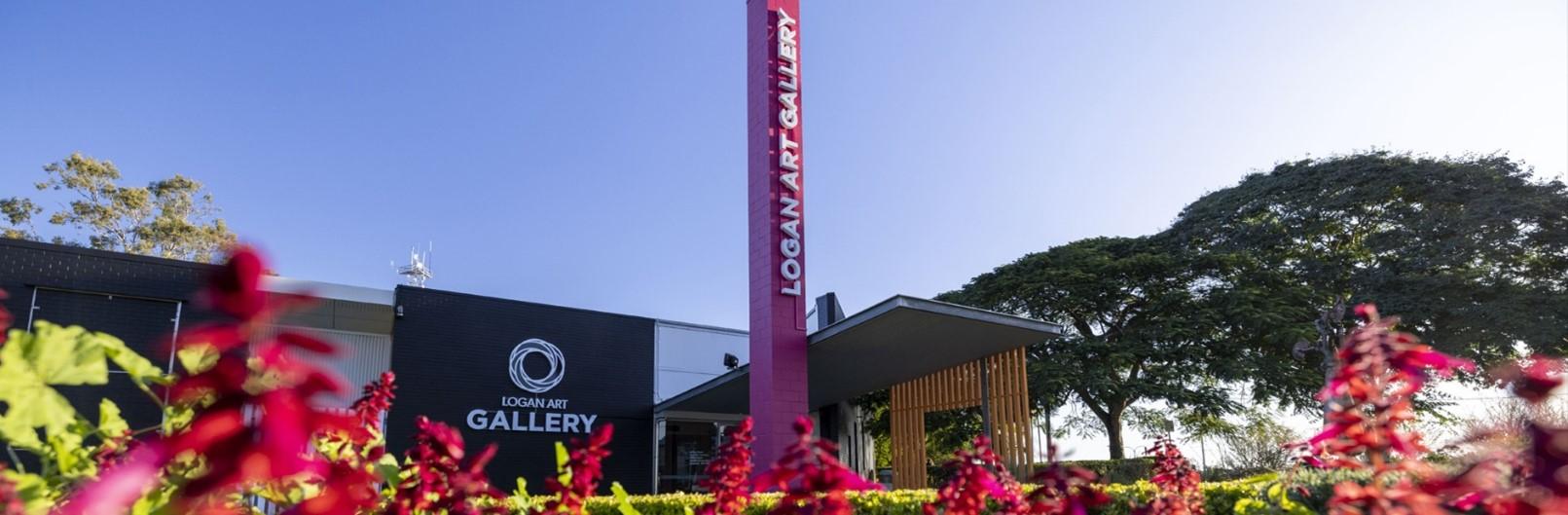 The Logan Art Gallery frontage with pink flowers in the foreground.
