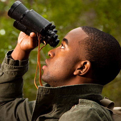 Man looks through binoculars