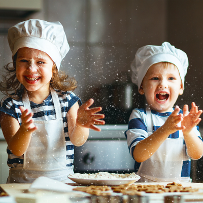 Two small children cooking