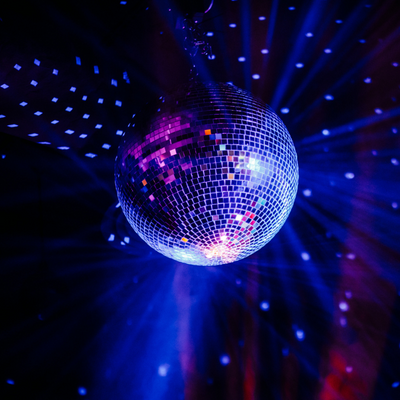 Mirrorball with blue and purple lights reflecting off it.