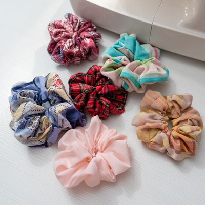 Flat lay of 8 scrunchies of carrying colours