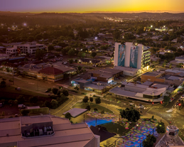 Aerial view of Logan showing a mixture of residential, commercial and industrial areas with a blue sky in the background