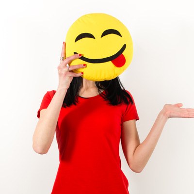 Person wearing a red shirt holding up a tongue out emoji