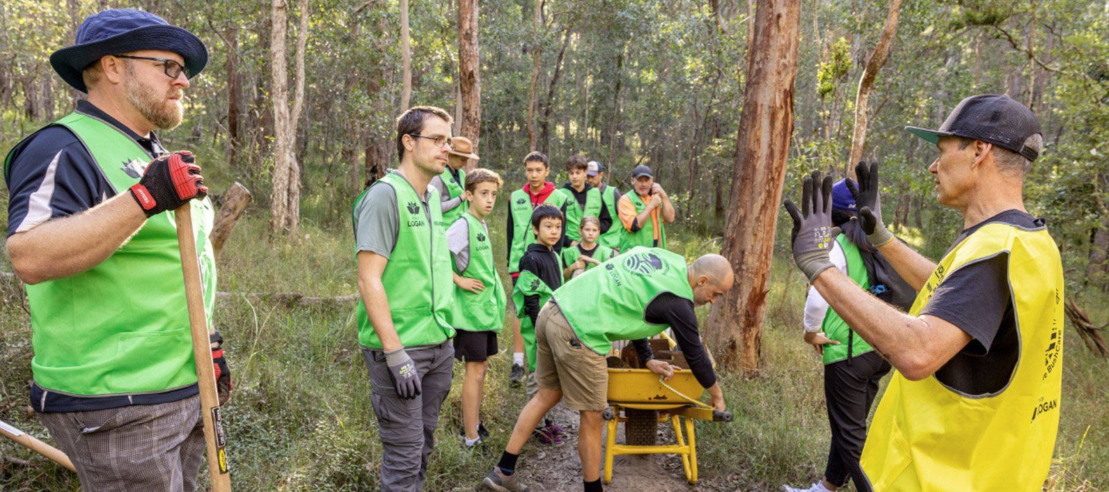 Group of volunteers dressed in high vis standing in the bush